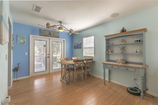 20433 Fern Cir, North Fort Myers, FL 33917 - dining room with light wood-style floors, french doors, and a ceiling fan
