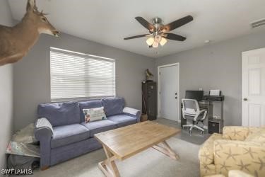 20433 Fern Cir, North Fort Myers, FL 33917 - living room with ceiling fan, a desk, and carpet flooring
