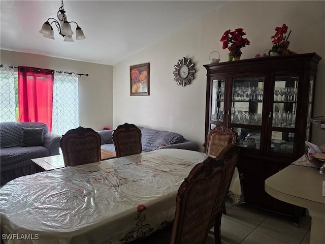328 Harold Ave S, Lehigh Acres, FL 33973 - dining space featuring lofted ceiling, tile patterned flooring, and a chandelier