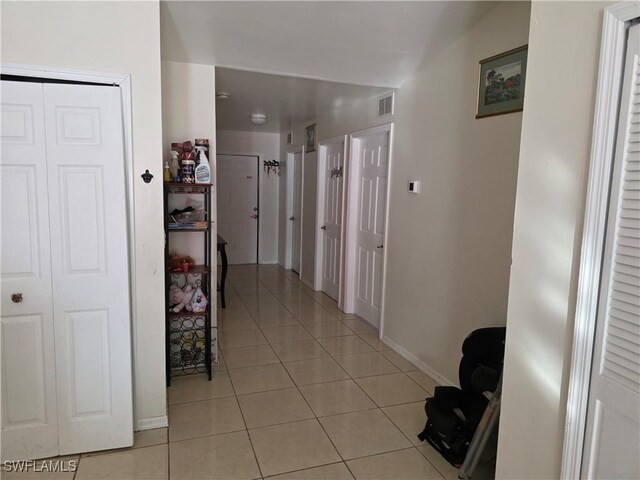 328 Harold Ave S, Lehigh Acres, FL 33973 - corridor with light tile patterned floors and baseboards