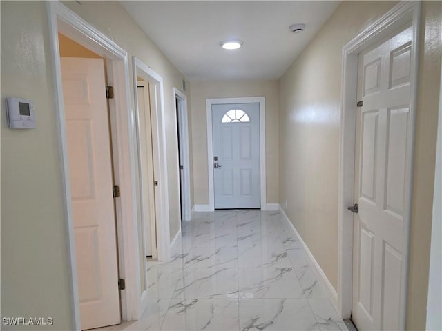 328 Harold Ave S, Lehigh Acres, FL 33973 - doorway to outside featuring baseboards and light marble finish floors