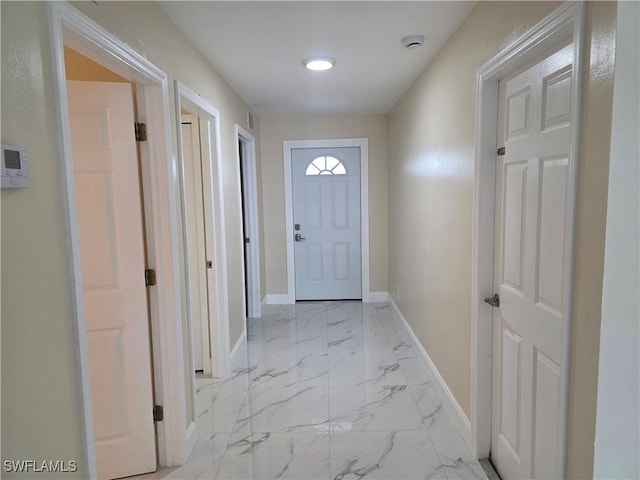 328 Harold Ave S, Lehigh Acres, FL 33973 - doorway with baseboards and light marble finish floors