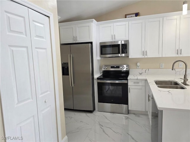 328 Harold Ave S, Lehigh Acres, FL 33973 - kitchen with appliances with stainless steel finishes, light marble finish flooring, light stone counters, and white cabinets