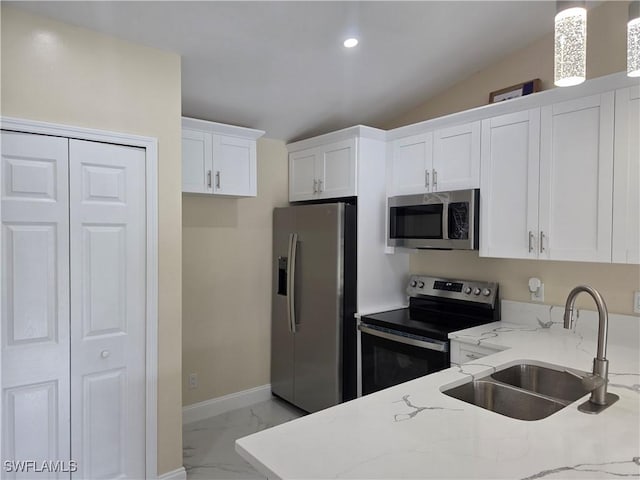 328 Harold Ave S, Lehigh Acres, FL 33973 - kitchen featuring appliances with stainless steel finishes, light marble finish flooring, light stone counters, white cabinetry, and recessed lighting