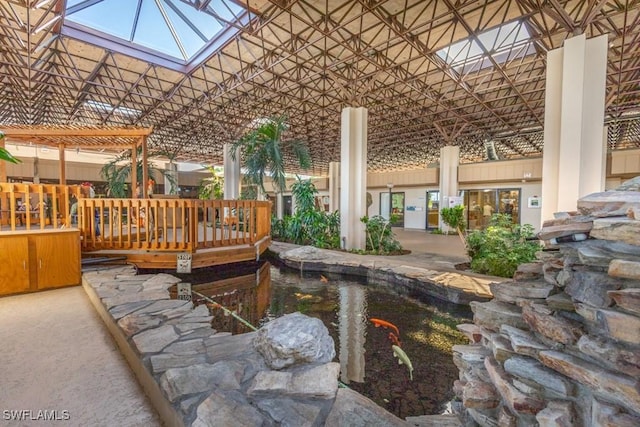 7430 Lake Breeze Dr Unit 403, Fort Myers, FL 33907 - lobby featuring a garden pond and a high ceiling