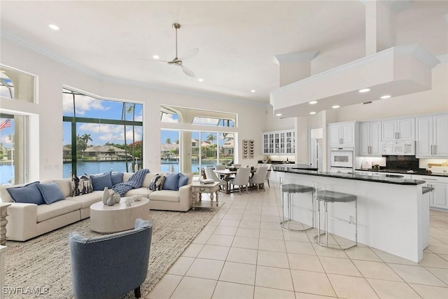 173 Gulfport Ct, Marco Island, FL 34145 - living area with ornamental molding, light tile patterned floors, a towering ceiling, recessed lighting, and a water view