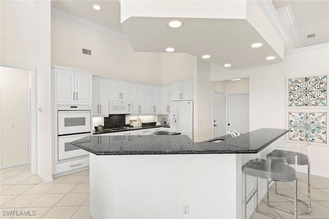 173 Gulfport Ct, Marco Island, FL 34145 - kitchen featuring white appliances, crown molding, light tile patterned floors, white cabinetry, and a sink