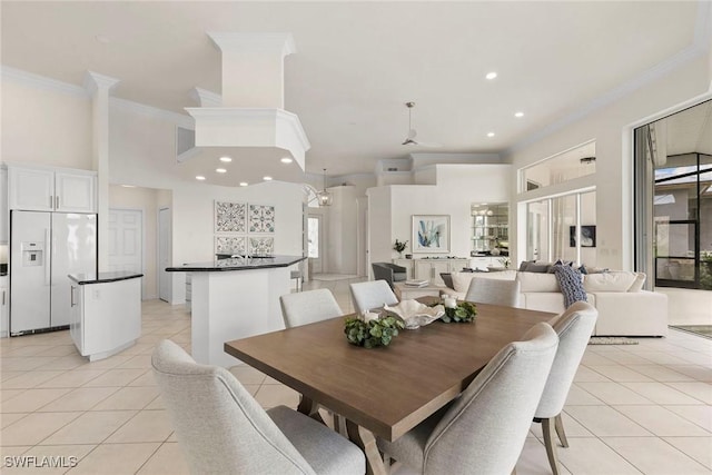 173 Gulfport Ct, Marco Island, FL 34145 - dining space with light tile patterned floors, ornamental molding, a towering ceiling, and recessed lighting