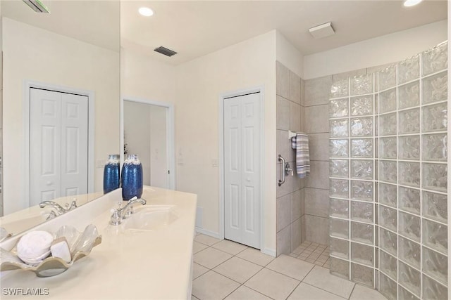 173 Gulfport Ct, Marco Island, FL 34145 - bathroom with a closet, tile patterned floors, vanity, walk in shower, and recessed lighting
