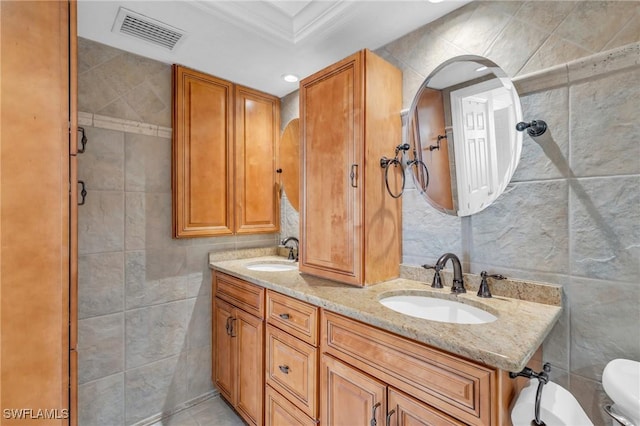 2810 Estero Blvd Unit 714, Fort Myers Beach, FL 33931 - full bathroom with tile walls, ornamental molding, double vanity, toilet, and recessed lighting