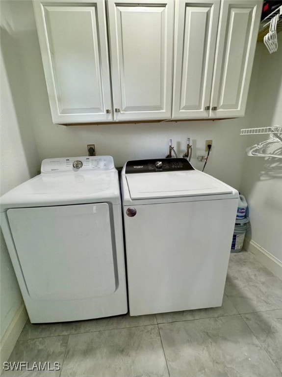 857 Palm View Dr Unit 32, Naples, FL 34110 - laundry room with cabinet space, independent washer and dryer, and baseboards