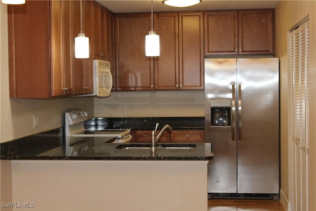 13391 Broadhurst Loop, Fort Myers, FL 33919 - kitchen featuring stainless steel fridge, electric range oven, white microwave, a peninsula, and brown cabinetry