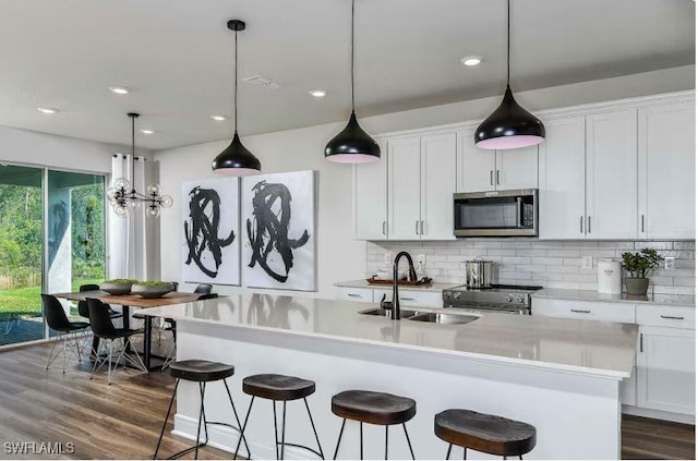 16935 Sage Ter, Punta Gorda, FL 33982 - kitchen featuring stainless steel appliances, a sink, decorative backsplash, light countertops, and recessed lighting