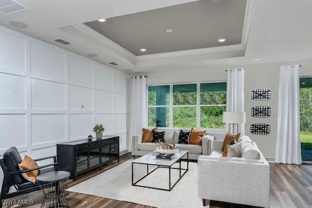 16935 Sage Ter, Punta Gorda, FL 33982 - living area with a decorative wall, wood finished floors, healthy amount of natural light, crown molding, and a raised ceiling