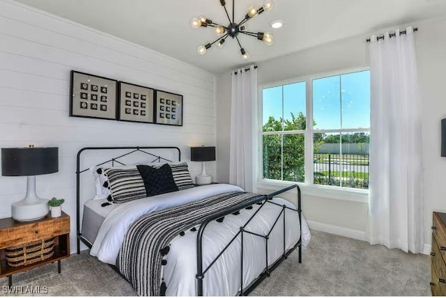 16935 Sage Ter, Punta Gorda, FL 33982 - bedroom with a chandelier, light carpet, wooden walls, and baseboards