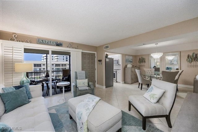 3200 Gulf Shore Blvd N Unit 403, Naples, FL 34103 - living area with a textured ceiling, a chandelier, and light tile patterned flooring