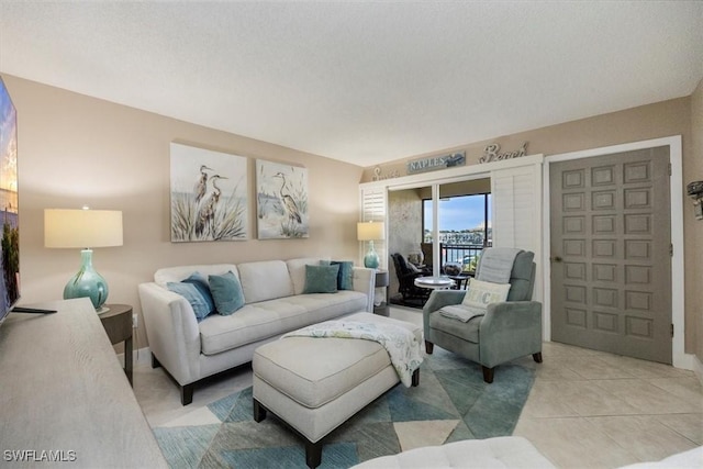 3200 Gulf Shore Blvd N Unit 403, Naples, FL 34103 - living room featuring light tile patterned flooring and baseboards