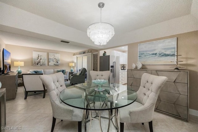 3200 Gulf Shore Blvd N Unit 403, Naples, FL 34103 - dining room with a chandelier and light tile patterned floors