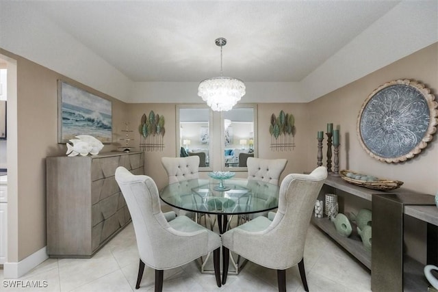3200 Gulf Shore Blvd N Unit 403, Naples, FL 34103 - dining area with light tile patterned floors and a chandelier