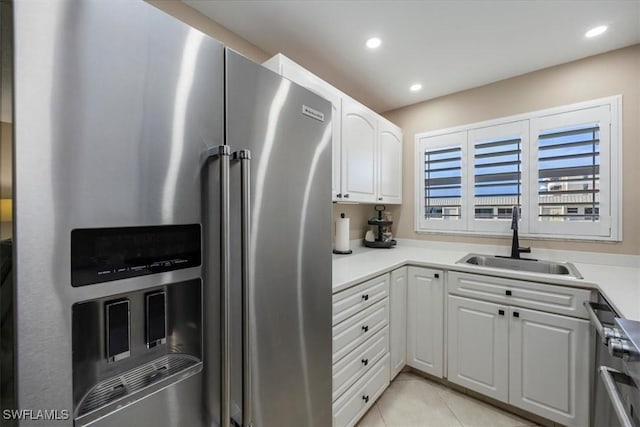 3200 Gulf Shore Blvd N Unit 403, Naples, FL 34103 - kitchen with appliances with stainless steel finishes, white cabinetry, recessed lighting, light tile patterned floors, and light countertops