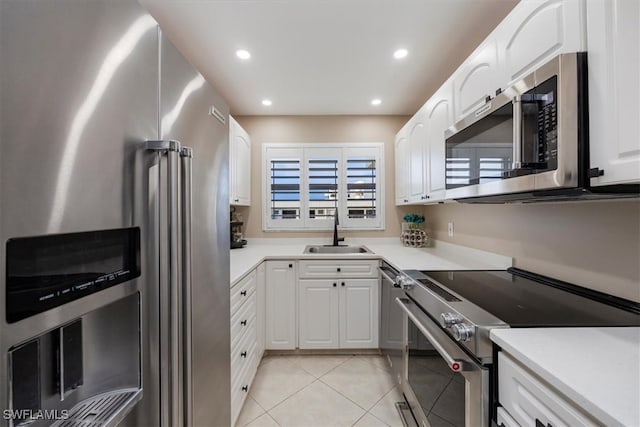 3200 Gulf Shore Blvd N Unit 403, Naples, FL 34103 - kitchen featuring appliances with stainless steel finishes, light tile patterned floors, white cabinets, and recessed lighting