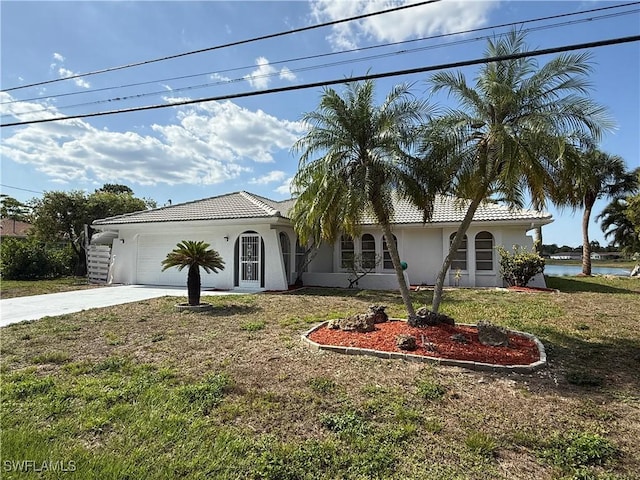 2803 E 5th St, Lehigh Acres, FL 33972 - view of front facade featuring stucco siding, driveway, a tiled roof, an attached garage, and a front yard