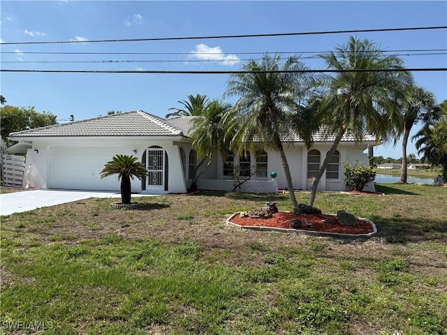 2803 E 5th St, Lehigh Acres, FL 33972 - view of front of property featuring stucco siding, a garage, and a front lawn