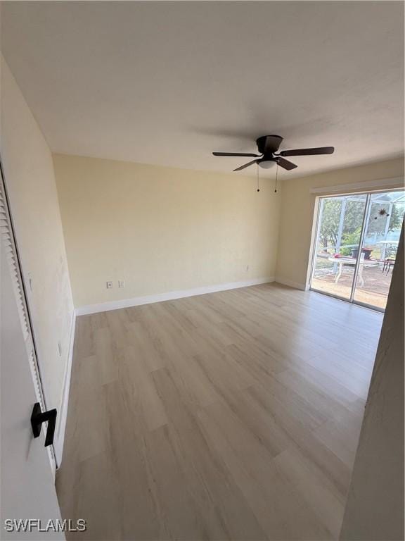 2803 E 5th St, Lehigh Acres, FL 33972 - unfurnished room featuring light wood finished floors, a ceiling fan, and baseboards
