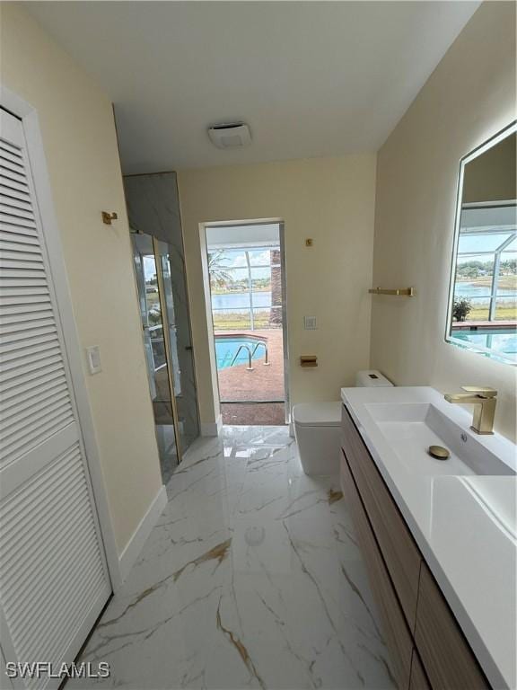 2803 E 5th St, Lehigh Acres, FL 33972 - bathroom featuring vanity, toilet, a closet, baseboards, and marble finish flooring