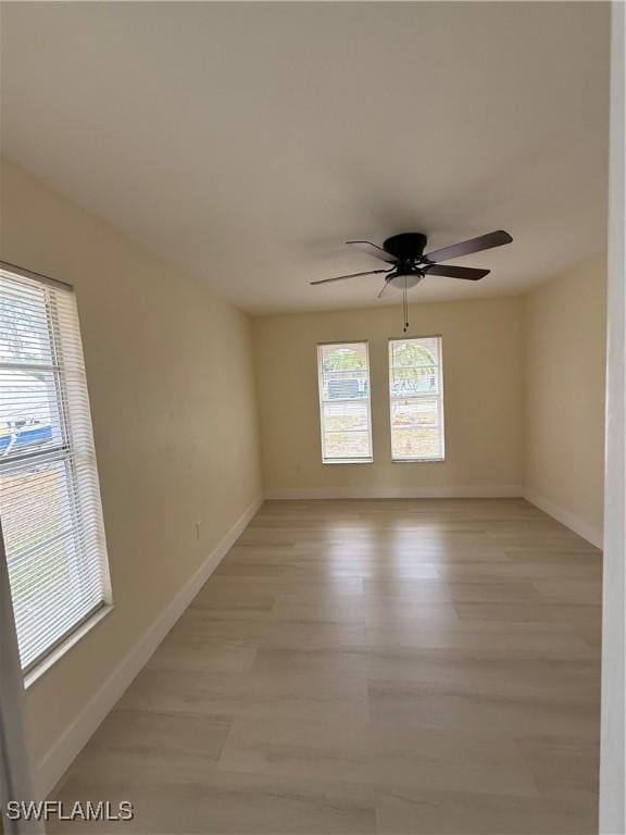 2803 E 5th St, Lehigh Acres, FL 33972 - empty room featuring plenty of natural light, light wood-style flooring, and ceiling fan
