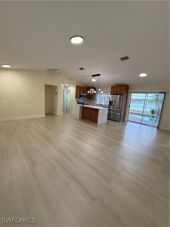 2803 E 5th St, Lehigh Acres, FL 33972 - unfurnished living room with light wood-style flooring, baseboards, recessed lighting, and a sink