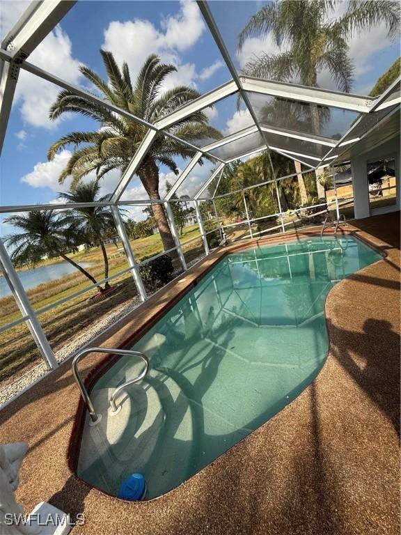 2803 E 5th St, Lehigh Acres, FL 33972 - outdoor pool featuring glass enclosure and a patio