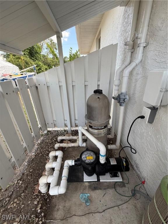 2803 E 5th St, Lehigh Acres, FL 33972 - exterior view of stucco siding and pump