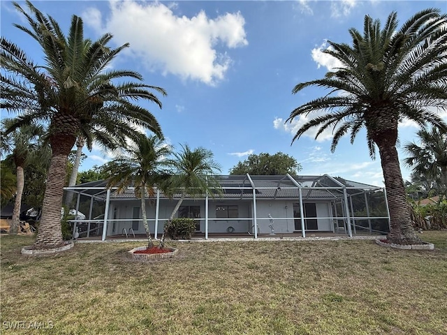 2803 E 5th St, Lehigh Acres, FL 33972 - rear view of property with a yard and a lanai