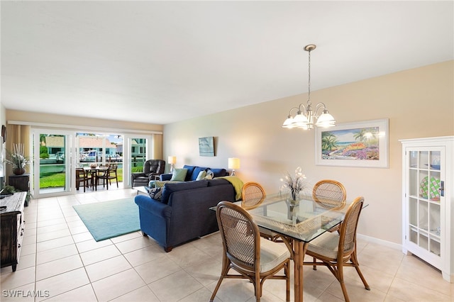 860 Panama Ct Unit 107, Marco Island, FL 34145 - dining room featuring a chandelier, light tile patterned flooring, and baseboards