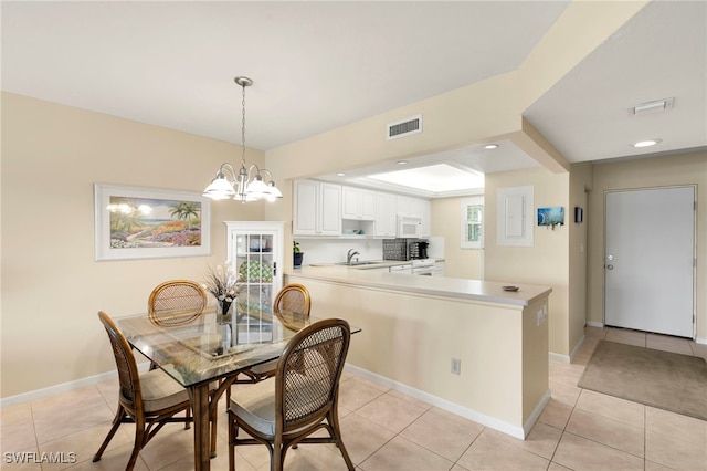 860 Panama Ct Unit 107, Marco Island, FL 34145 - dining room with light tile patterned flooring, a chandelier, baseboards, and recessed lighting