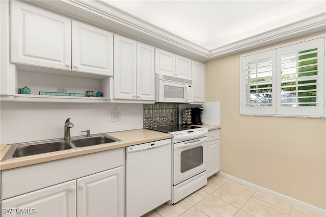 860 Panama Ct Unit 107, Marco Island, FL 34145 - kitchen featuring white appliances, a sink, light tile patterned flooring, and white cabinetry