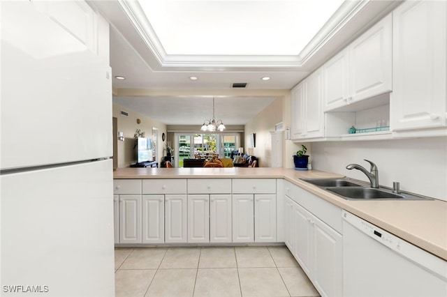 860 Panama Ct Unit 107, Marco Island, FL 34145 - kitchen with white appliances, a sink, light tile patterned floors, light countertops, and white cabinets