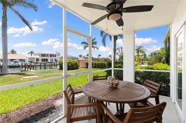 860 Panama Ct Unit 107, Marco Island, FL 34145 - sunroom / solarium with a ceiling fan, a water view, a residential view, and outdoor dining area