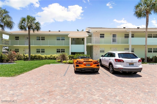 860 Panama Ct Unit 107, Marco Island, FL 34145 - view of building exterior featuring uncovered parking