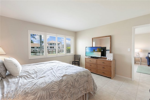 860 Panama Ct Unit 107, Marco Island, FL 34145 - bedroom featuring light tile patterned flooring and baseboards