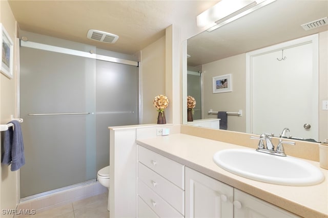 860 Panama Ct Unit 107, Marco Island, FL 34145 - bathroom featuring vanity, toilet, a shower stall, and tile patterned flooring