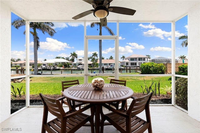 860 Panama Ct Unit 107, Marco Island, FL 34145 - sunroom / solarium with a water view, a ceiling fan, a residential view, and outdoor dining space