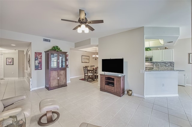 10011 Sky View Way Unit 1803, Fort Myers, FL 33913 - living area featuring light tile patterned flooring, ceiling fan, and baseboards