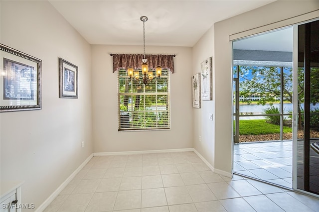 10011 Sky View Way Unit 1803, Fort Myers, FL 33913 - unfurnished dining area featuring a water view, a chandelier, light tile patterned floors, and baseboards