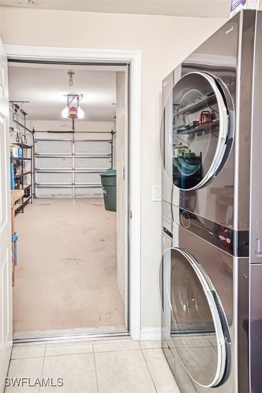 10011 Sky View Way Unit 1803, Fort Myers, FL 33913 - washroom featuring estacked washer and dryer, a garage, and tile patterned flooring