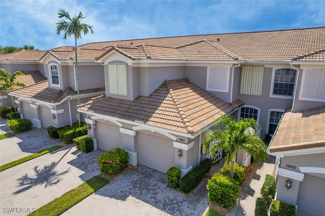 10011 Sky View Way Unit 1803, Fort Myers, FL 33913 - view of front of property with a tile roof, decorative driveway, and stucco siding