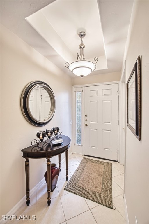 10011 Sky View Way Unit 1803, Fort Myers, FL 33913 - foyer with a raised ceiling, light tile patterned floors, and baseboards