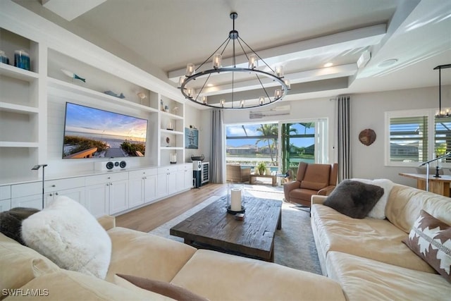 14372 Neptune Ave, Naples, FL 34114 - living room featuring a chandelier, built in shelves, and light wood finished floors