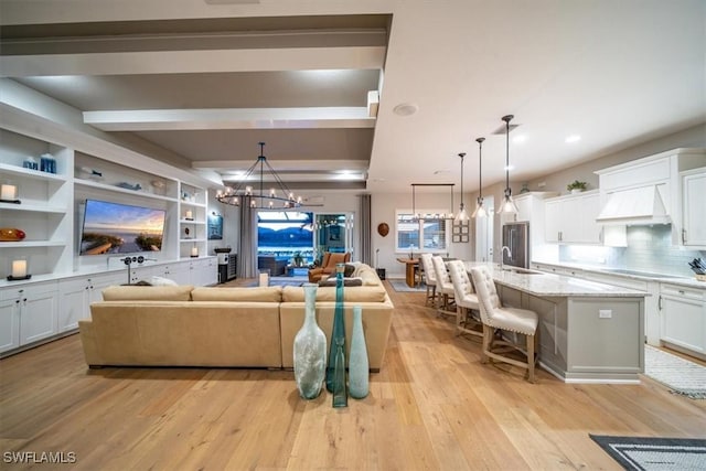 14372 Neptune Ave, Naples, FL 34114 - living room featuring a chandelier, light wood-style floors, beam ceiling, and recessed lighting